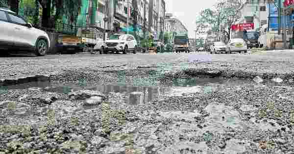 Potholes and broken road surface in Hyderabad putting stress on car tyres and wheels